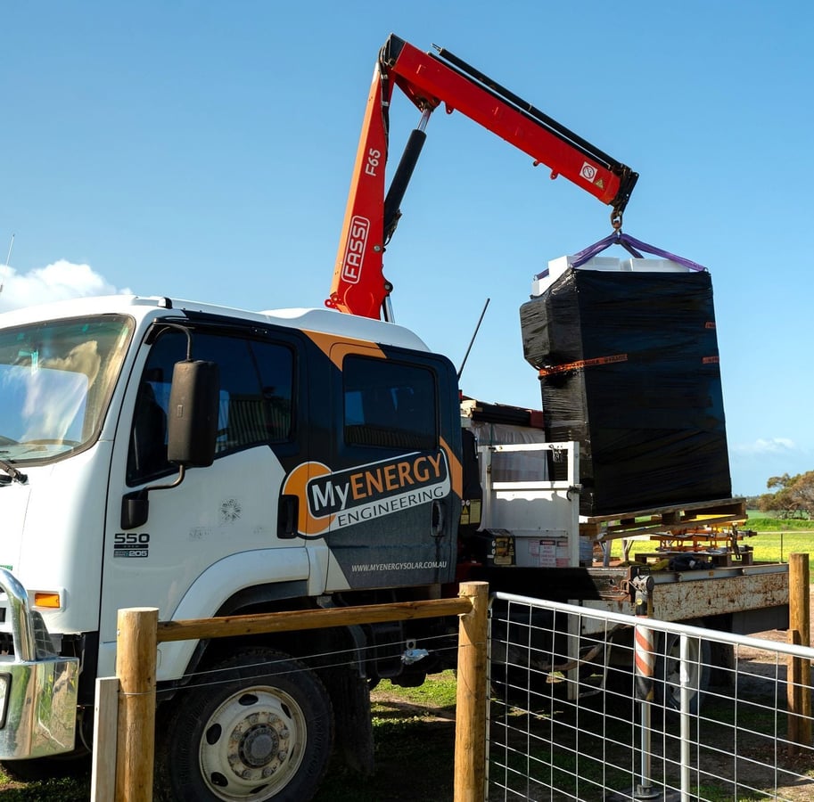 A MyEnergy power cabinet being unloaded from the company truck