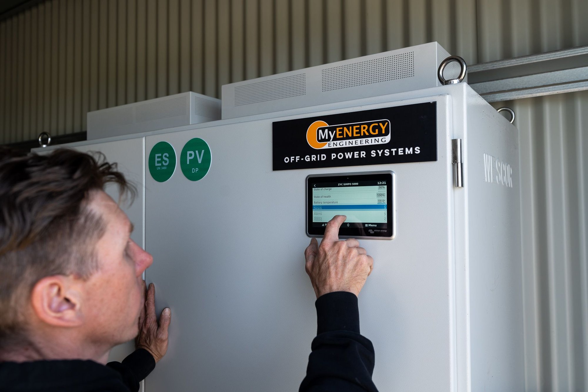 brad programming an off grid power system that has just been installed in goolwa, south australia. product featured is the cerbo monitor on the external door of the cabinet.