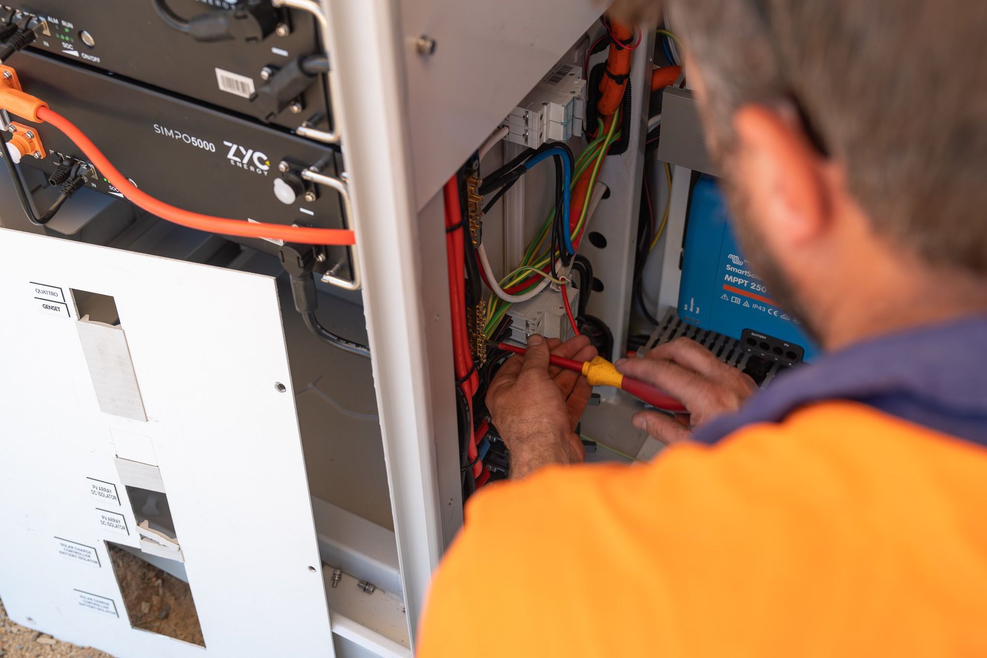 greg, lead electrician at MyEnergy Engineering completing a cabinet installation, wiring and assembly.
